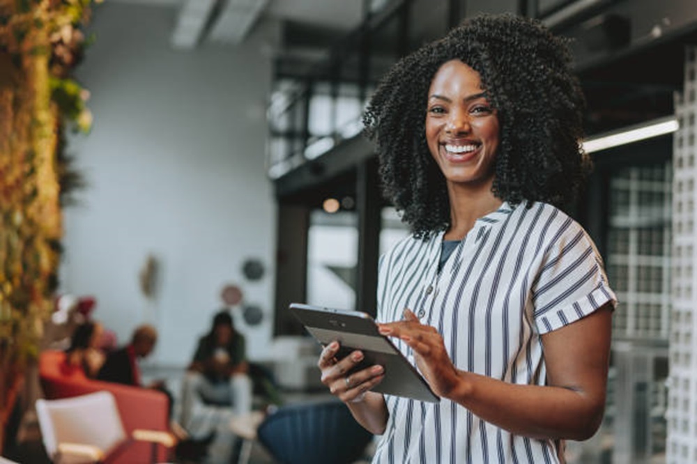 Business woman holding digital tablet smiling